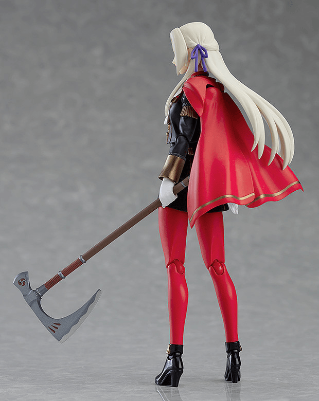 A collectible action figure of a female warrior shown from the back, featuring long white hair, a red cape with gold trim, red tights, a black bodysuit, and black boots, holding a large gray and brown scythe against a gray studio background.