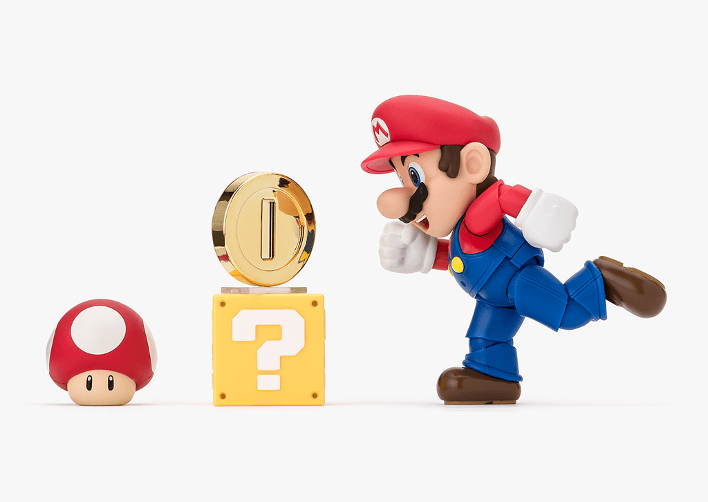 Super Mario figurine with mushroom, question block, and power-up on a white background