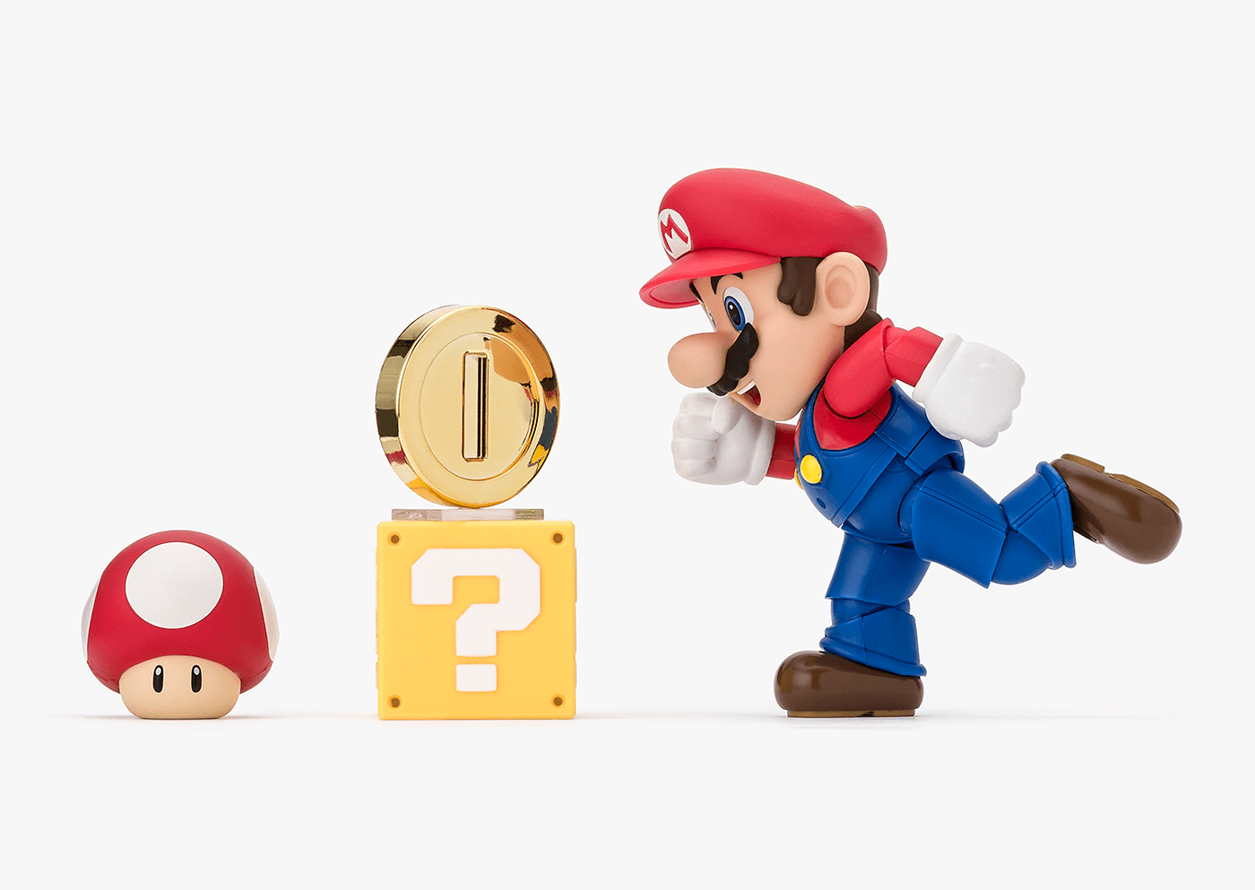Super Mario figurine with mushroom, question block, and power-up on a white background