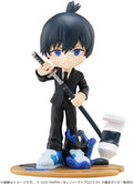 Figurine of a character in a black suit holding a sword on a white background