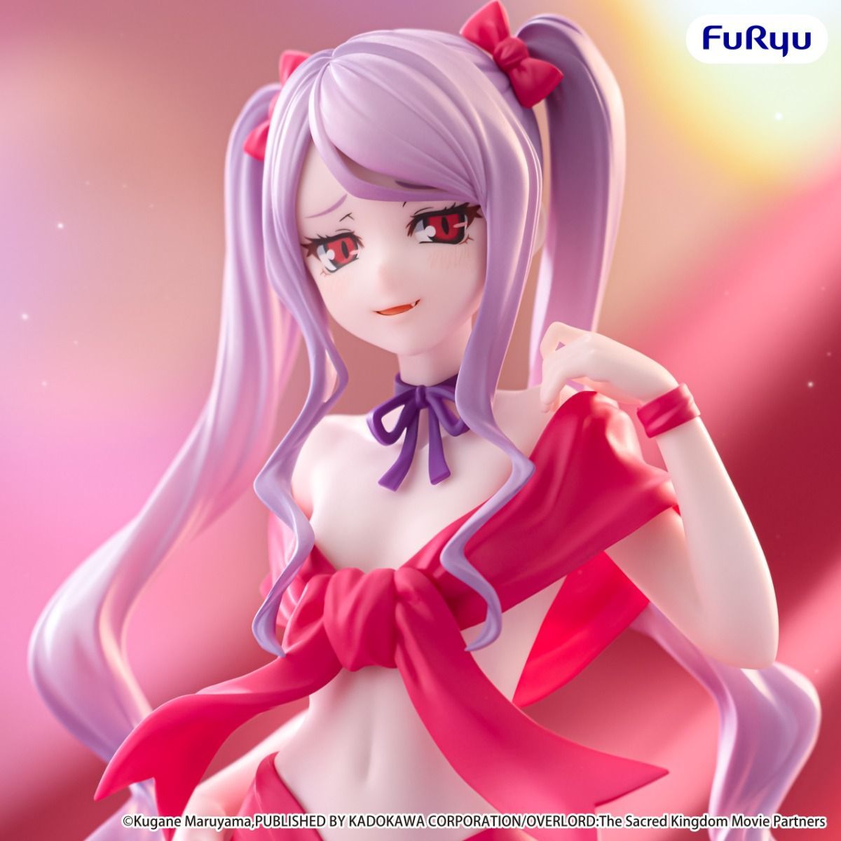 Figurine with long purple hair and red bows, wearing a red outfit with a bow tie, on a pink background.