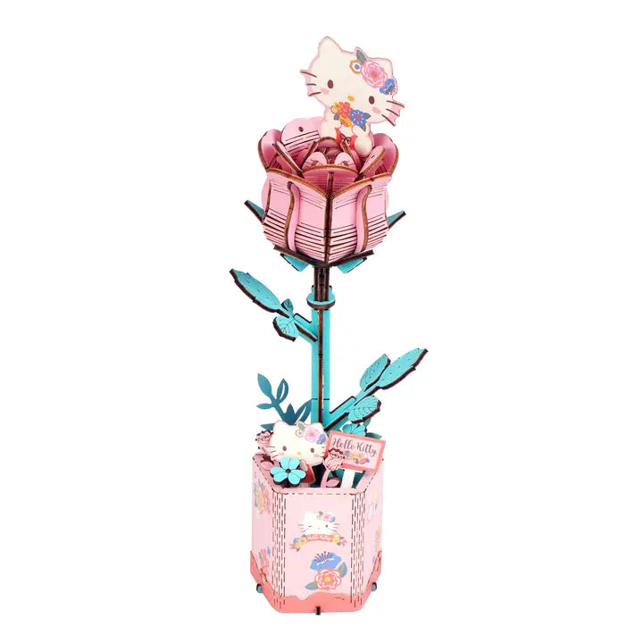 A pink Hello Kitty-themed 3D rose-shaped box with a decorative base, featuring cartoon cat characters and pastel floral details on a plain white background.