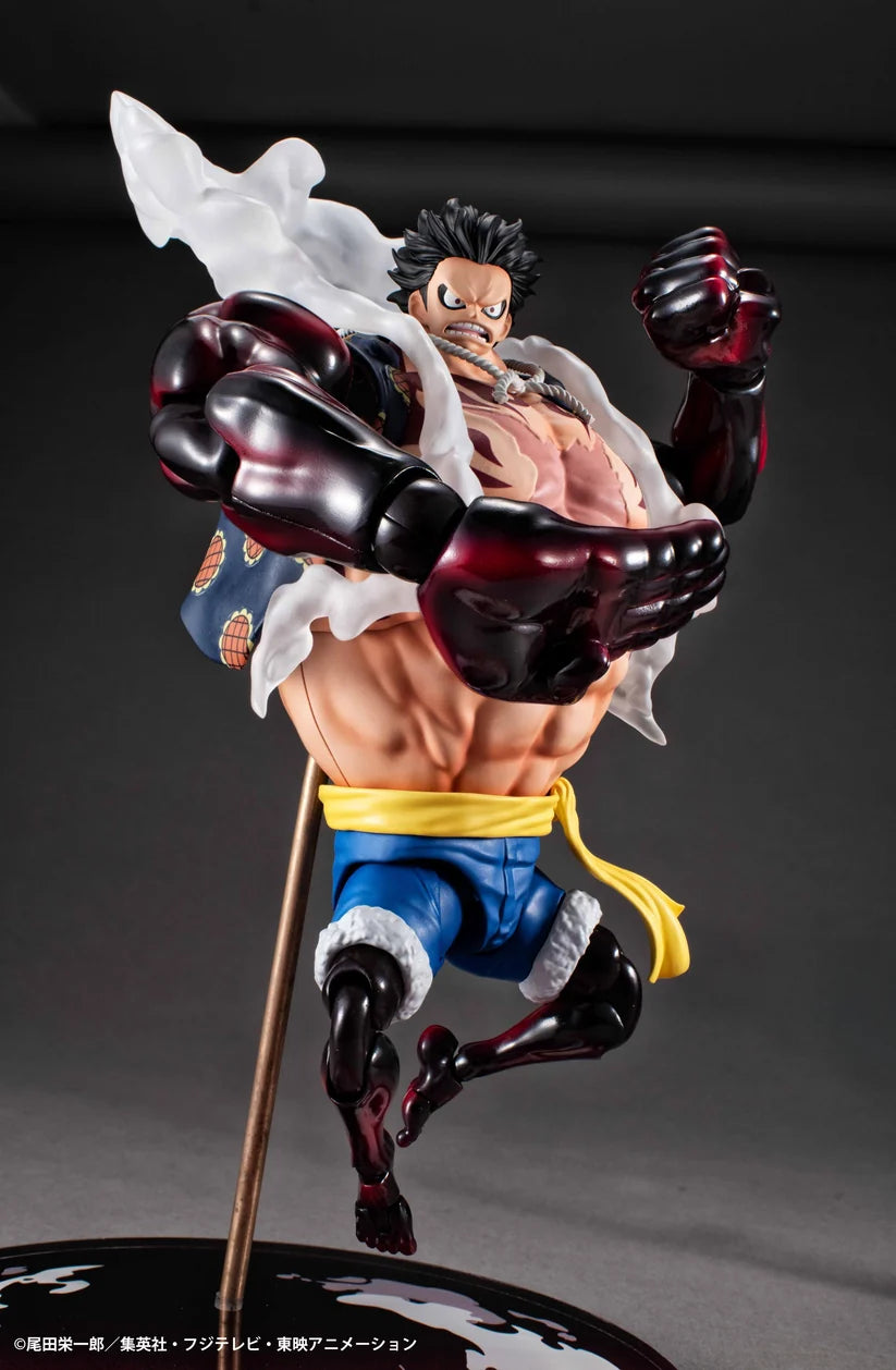 Action figure of a muscular character with a staff on a dark background