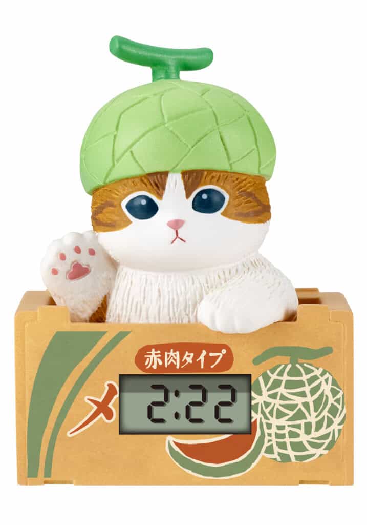 Cat-shaped clock figurine with a green hat and digital display on a white background