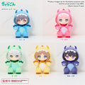 Five chibi-style plush figures wearing colorful dragon/cosplay hooded outfits arranged in a 2x3 grid on a light marble background. The figures include blue, pink, mint green, yellow, and dark purple colorways, with anime-style faces and paw details visible.
