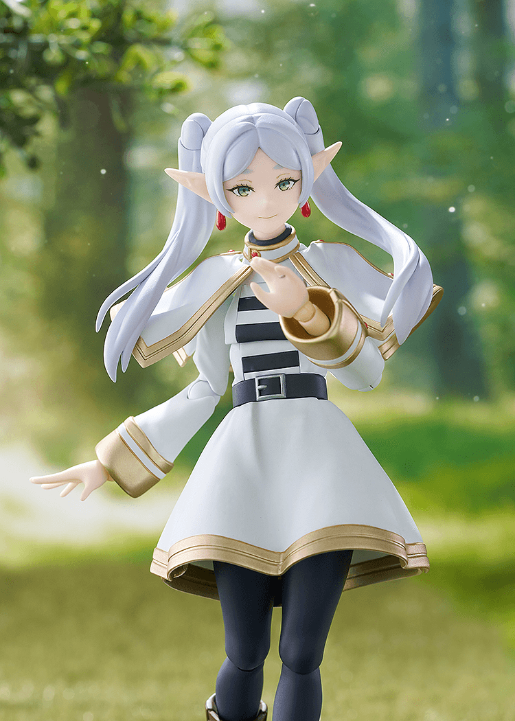 Figurine of a character with white hair and elf-like ears, holding a golden staff, against a blurred natural background.