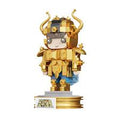 A golden anime-style collectible figurine of a warrior in detailed armor with blue accents, standing on a gold base against a plain white background.