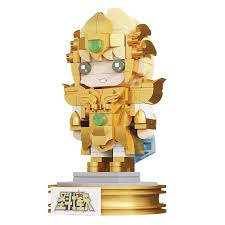A small gold-colored blocky anime figurine of a character in armor, standing on a round display base with a card attached at the bottom, photographed against a plain white background.
