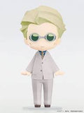 A chibi-style collectible figurine of a man with light green hair and round green-tinted glasses, wearing a light gray suit. The figure is shown against a clean, light gray gradient background.