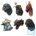 Collection of various monster head figurines on a white background with Bandai logo.