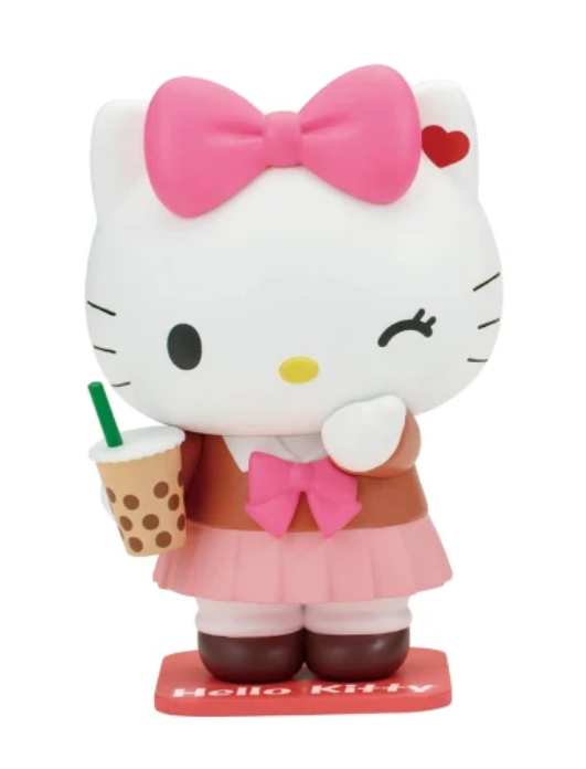 Hello Kitty collectible figure in a brown and pink outfit, holding a bubble tea cup, on a white background.