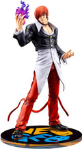 Action figure with red hair and black outfit holding a purple object on a white background