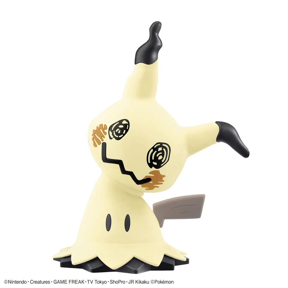 Toy figure of a ghostly creature with black accents on a white background