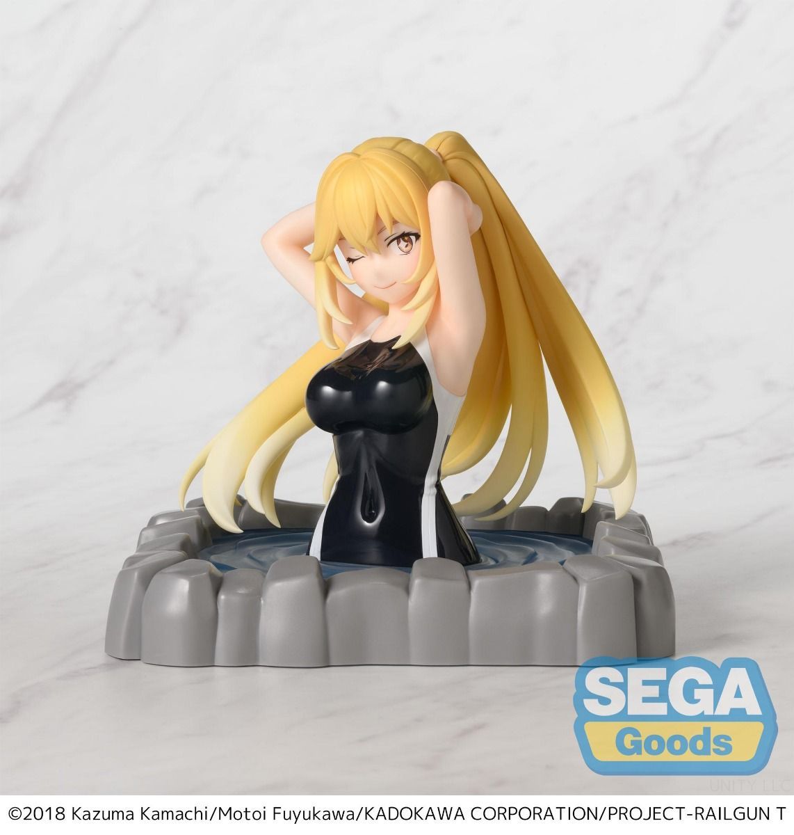 Figurine of a character with long blonde hair and a black outfit on a gray stand, with 'SEGA Goods' logo.