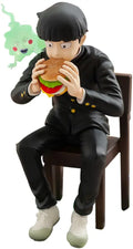A collectible figurine of a character in a black uniform sitting on a brown chair and eating a hamburger, with a small green ghost character floating near the head, isolated on a white background.
