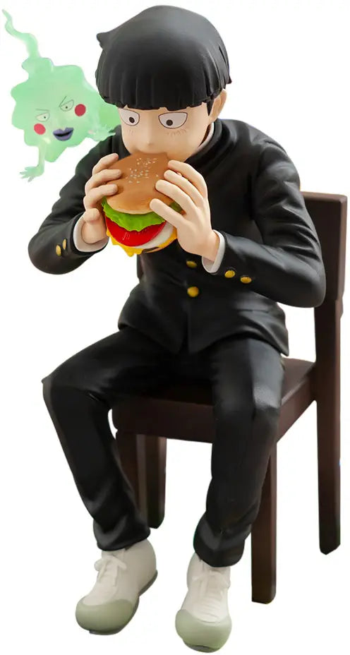 A collectible figurine of a character in a black uniform sitting on a brown chair and eating a hamburger, with a small green ghost character floating near the head, isolated on a white background.