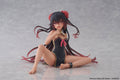 Anime character figurine in a black swimsuit with red hair accessories on a gray background