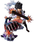 Action figure of a character with spiky black hair and orange shorts, holding a large weapon on a white background.