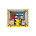 A Pikachu figurine displayed inside a miniature yellow storefront diorama with blue walls, a red vending machine, and small shop accessories.