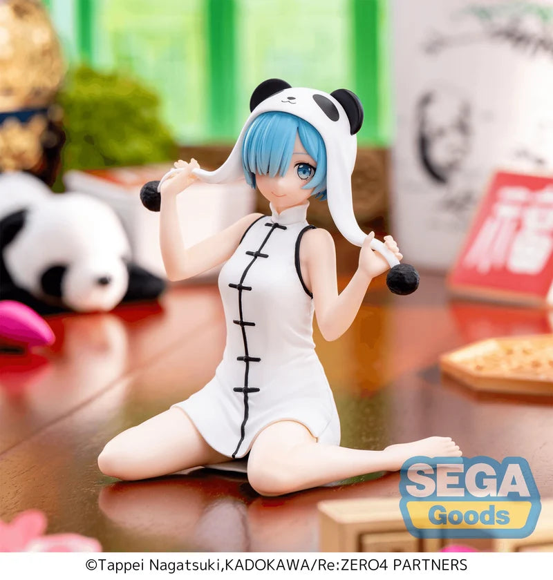 Figurine of a character in a panda costume with blue hair, sitting on a reflective surface with 'Sega Goods' branding.