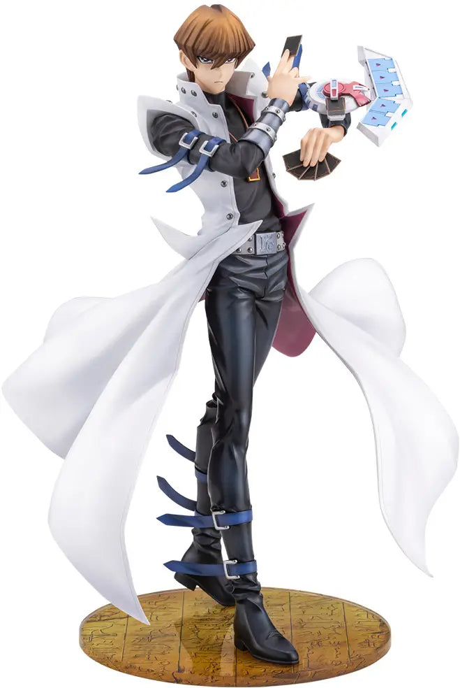 A detailed anime figurine of a male character with brown hair, wearing a white coat over a black outfit, holding a blue and white device, standing on a circular wooden base against a white background.