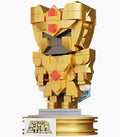 A golden block-built mecha figurine standing on a display base, shown against a plain white background.