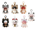 Six small plush character keychains arranged in two rows on a plain white background. Each plush has a cat- or animal-inspired hood with ears and tail details, plus a ring loop at the top and a small hanging charm or tag.