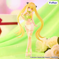A collectible anime figurine of a blonde female character with black cat ears, wearing a light green bikini top and white wrap skirt, posed against a soft green and pink backdrop with white roses in the foreground. The brand logo 'FuRyu' appears in the top right.
