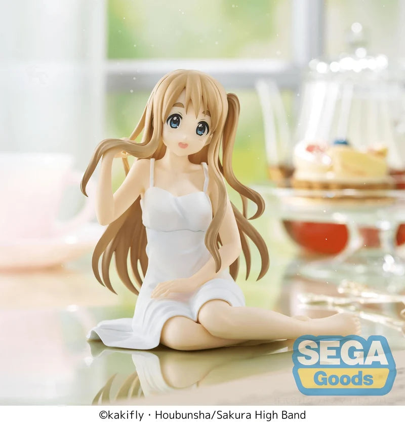Figurine of a character in a white dress sitting on a surface with 'SEGA Goods' branding.