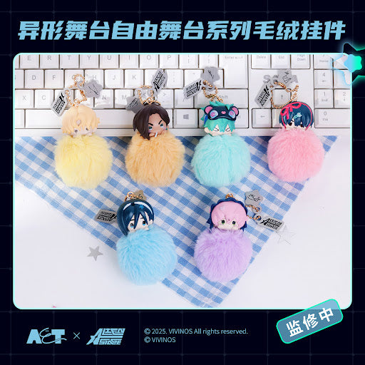 Colorful plush keychains on a checkered cloth with a keyboard in the background